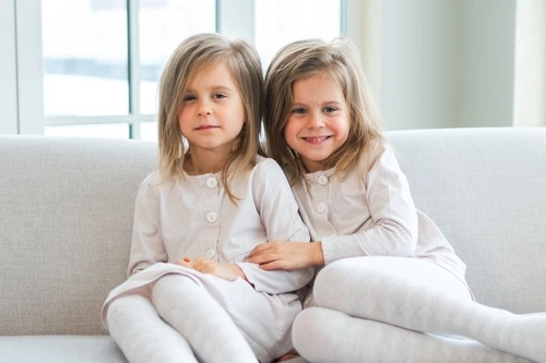 Twin girls on a couch