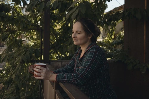 Woman at railing holding a mug
