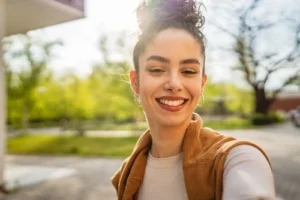young woman taking outdoor selfie